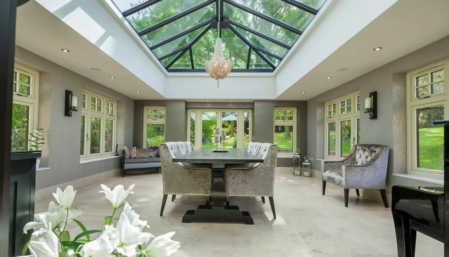 Photo of indoor conservatory room with windows all around and through the roof