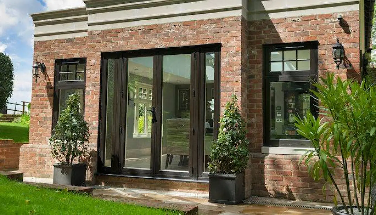 Photo of Black windows and windowed door of a house from the garden