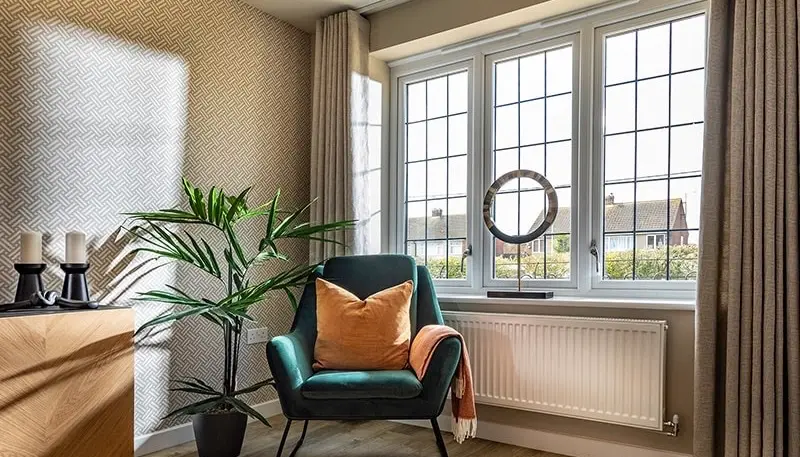 Photo of a sofa chair and room with windows behind, home interior